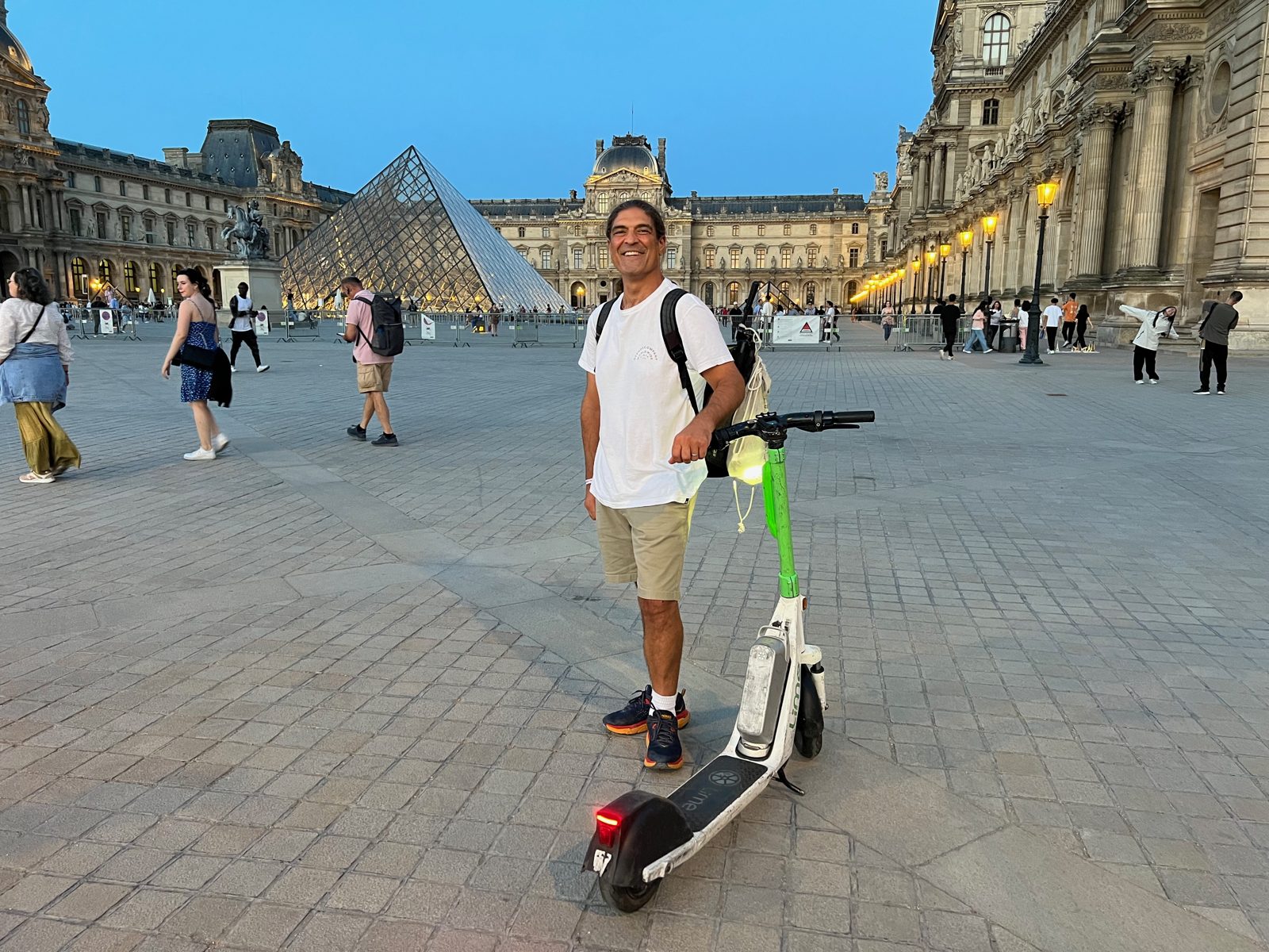 Nico on a scooter by the Louvre in Paris